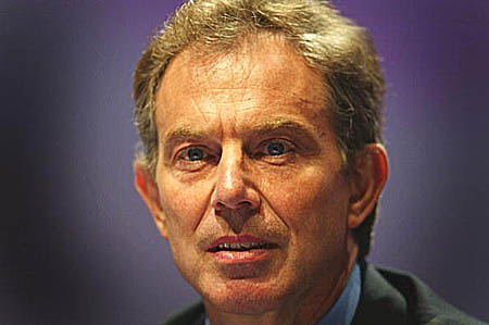 A close-up, slightly distorted, high-contrast photograph of Tony Blair's face, appearing ashen and mask-like.